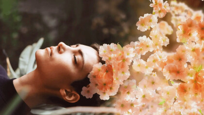 A woman practicing holotropic breathwork exercises