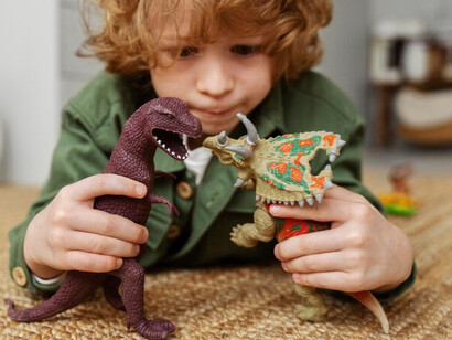 A child enjoys playtime on the carpet at home