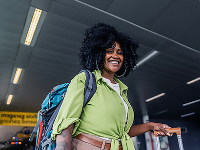 Portrait of a middle-aged woman at the airport, waiting for a taxi