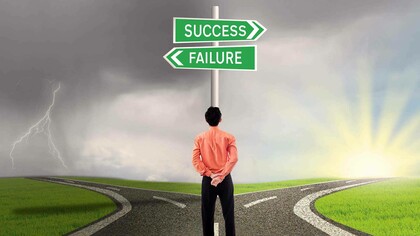 
A man at a crossroads as to which path to take where one leads to failure and the other to success
