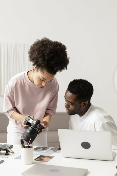 A creative team refining visual content on camera and screen, reflecting the strategic role of design in shaping public perception
