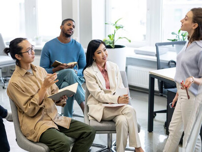 An audience engaged with a young female leader’s speech