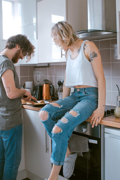 In the kitchen, a loving couple shares a moment that embodies their relationship