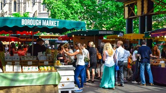 Local vendors welcoming visitors at Borough Market in London, presenting the city's commitment to preserving its culinary traditions