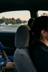 A child processing a painful loss in the back seat, representing the moments when parental support matters most