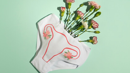 On white underwear, flowers highlighting the importance of menstrual health awareness and personal care