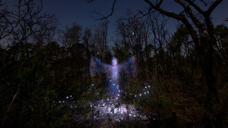 An apparition surrounded by energy and lights