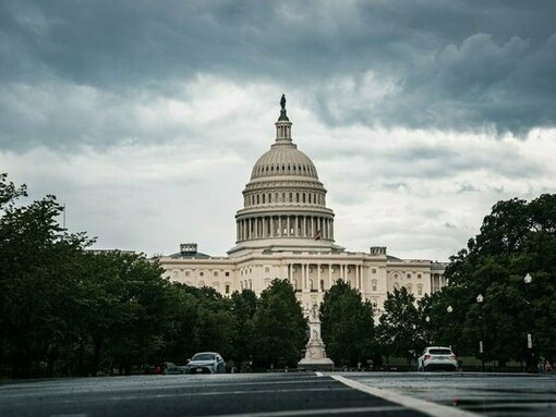 The U.S. Capitol standing beneath heavy storm clouds, representing the uncertainty surrounding America’s democratic institutions