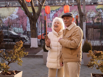 Side view of cheerful senior individuals enjoying the outdoors with smiles
