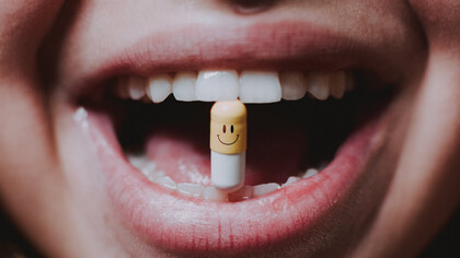 A woman gracefully takes her medication, swallowing it with ease and assurance