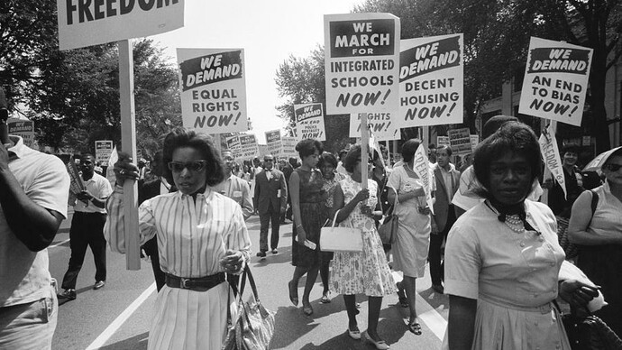 Washington, D.C. August 28, 1963, The civil rights march on Washington with a procession of African Americans carrying signs for equal rights and integrated schools