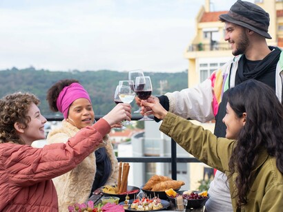 Travellers raising their glasses in celebration, representing the joy of finding community while exploring the world alone