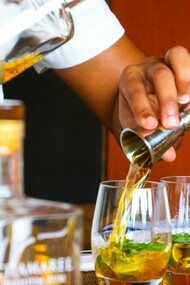 Bartender making drinks for patrons