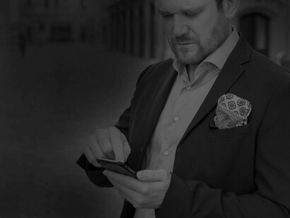 A Millennial scoping his competition on his phone as he attempts to make the big push to be the next successor at the company