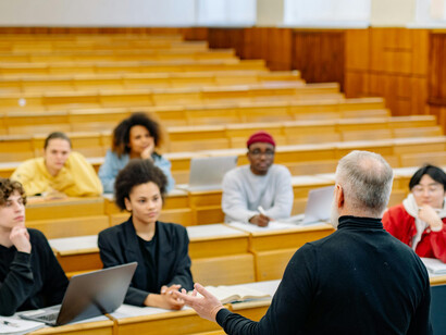 Students are engaged in a lecture inside a university classroom