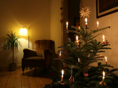 A glowing Christmas tree with string lights symbolizes the Christmas spirit, joyful decorations, and cherished holiday traditions