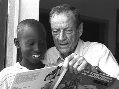 Jim Grant teaches reading to a young boy