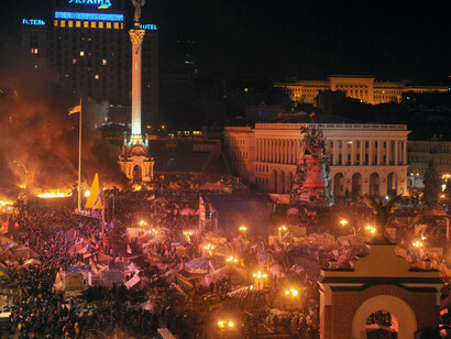 Flames engulfed the main anti-government protest camp on Kyiv's Independence Square as riot police tried to force demonstrators out following the bloodiest clashes in three months of protests. The iconic square turned into a war zone as riot police moved slowly through opposition barricades from several directions, hurling stun grenades and using water cannons to clear protestors, 2014
