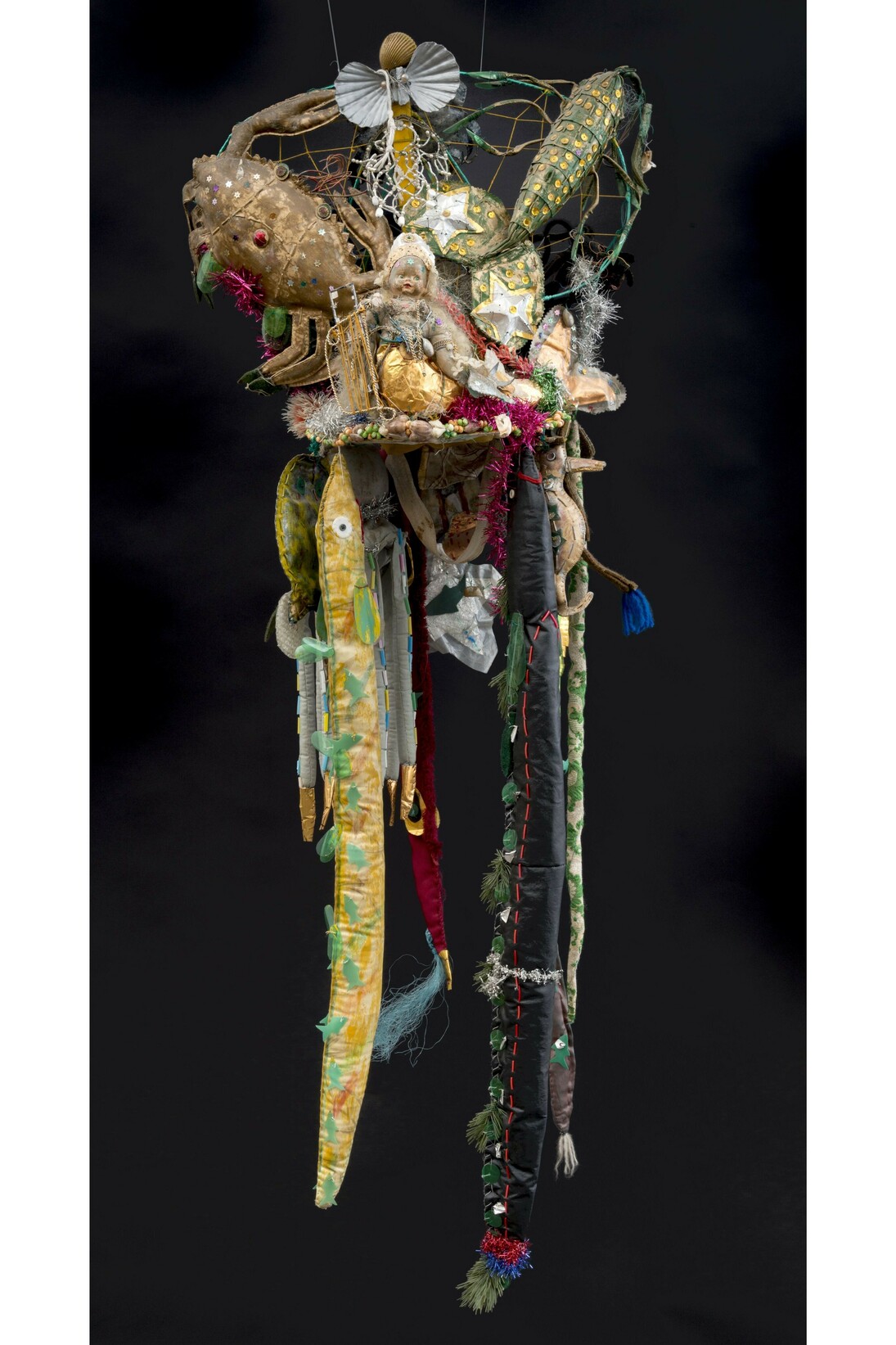 Raimundo Borges Falcão (dates unknown), Untitled (Hat—element from ceremonial costume in eleven parts, cape, bracelets, belt, scepters and skirt), Near Salvador, Bahia, Brazil, c. 1999, Textile fragments, leather, plastic, string, rope, tinsel, paper, carpeting, bubble wrap, cardboard, buttons, beads, purses, seashells, felt, beads, mirrors, dolls, metal, wood, candy wrappers, Christmas ornaments, costume jewelry, plastic bottles, and paint, Complete costume 92 x 36 x 25", Collection of Beate Echols and Michael Shub, New York City, Photo by Adam Reich © American Folk Art Museum