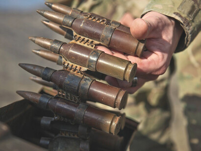 The well-equipped army loaded their weapons with cartridges, preparing for the upcoming mission