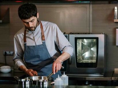 A chef works in the kitchen of a high-end restaurant