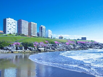 A vibrant coastal landscape overlooking the Atlantic, reflecting the contrast between Argentina's rich cultural identity and its fragile film archives