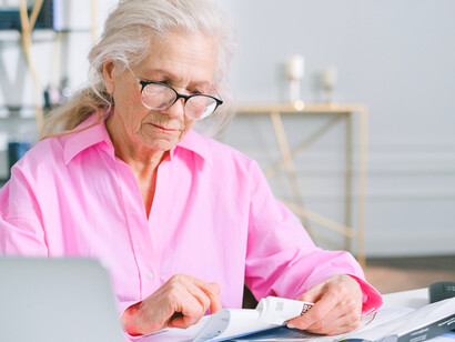 A senior citizen examining documents, symbolizing the growing concern over income security in later life