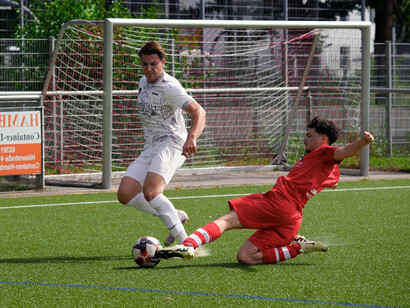 A winger attempts to dribble past a defender near the touchline