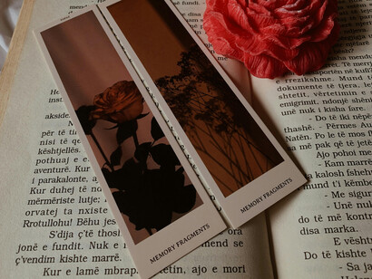 A bookmark and flower on an open book 