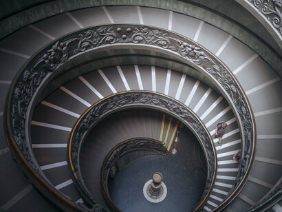 The spiral staircase of the Vatican Museums in Vatican City, representing how continuous architectural flow naturally guides movement