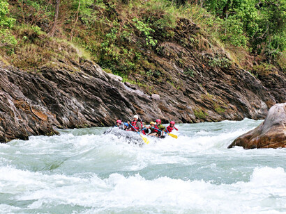 A team of rafters navigating the thrilling rapids of Nepal’s Trishuli River