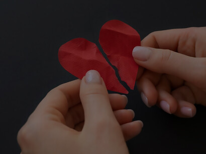 Person holding broken heart