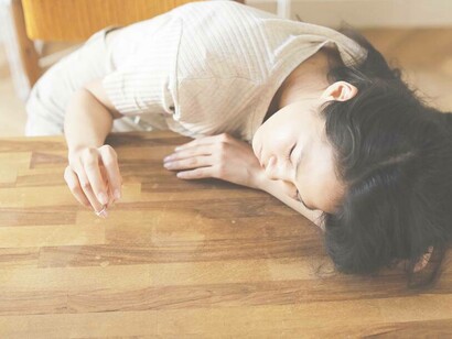 A woman resting her head from the trauma that she was cheated on