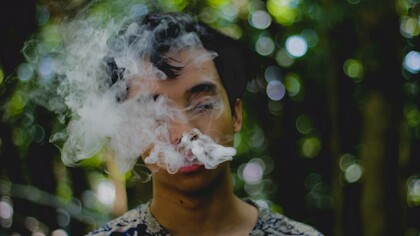 Man inhaling smoke