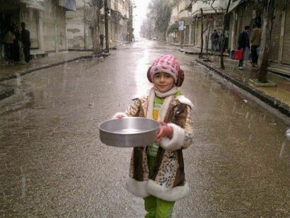 Little child under the rain in Homs