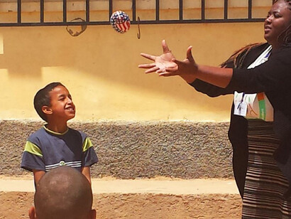 A young boy playing with his teacher