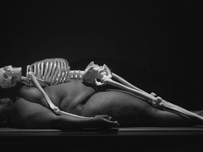 Photograph by Jonathan Muzikar: Marina Abramović's artwork featuring a nude person beneath a skeleton