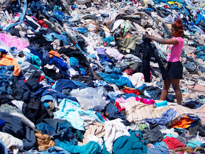 Mountains of discarded clothing pile up in landfills, a testament to the relentless cycle of overconsumption driven by fast fashion