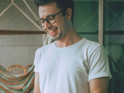 Smiling at his phone, he's enjoying the positive connections and uplifting content that make social media a source of joy rather than stress