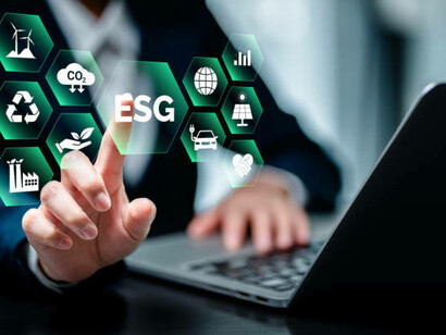 A person working on a laptop surrounded by icons symbolizing the circular economy, sustainability, recycling, and eco-conscious business strategies, reflecting the harmony between environmental and economic objectives