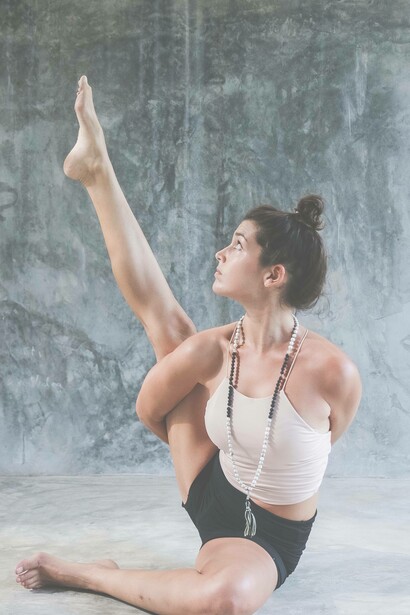 A woman looks upwards while practicing yoga