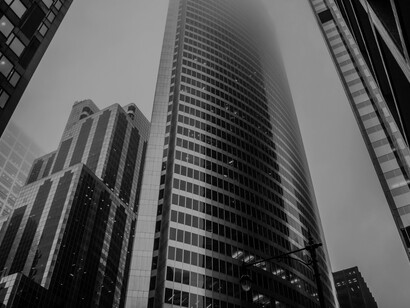 A low-angle shot of skyscrapers in the financial district skyline, capturing the cityscape as a symbol of business and the modern economy