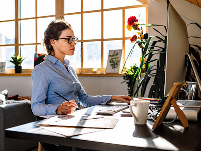 Young professional working remotely from a home office in a flexible work environment