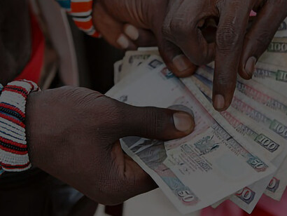 A picture featuring a confident woman holding a stack of African currency notes represents her thriving business ventures, the wealth of the region, and the abundant natural resources found in Africa