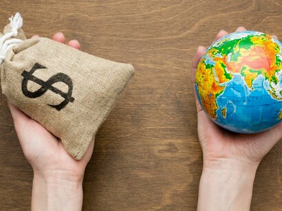 Stacks of money and financial documents represent the dynamic and influential nature of the global economy. This image emphasizes the critical role of economic factors in shaping international trade policies and addressing global challenges