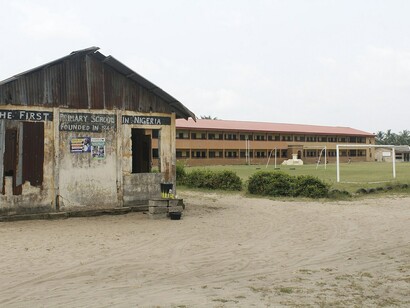 A weathered sign marks “The first primary school in Nigeria” symbolizing a system that struggles to help its people potential 