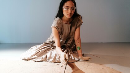 A woman taking care of a tree is a symbol of the last chance to avoid a climate disaster