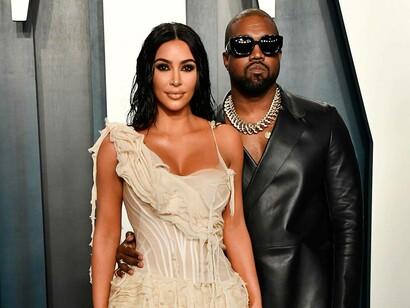 Kim Kardashian and Kanye West posing on the red carpet at the Vanity Fair Oscar Party in Beverly Hills, USA