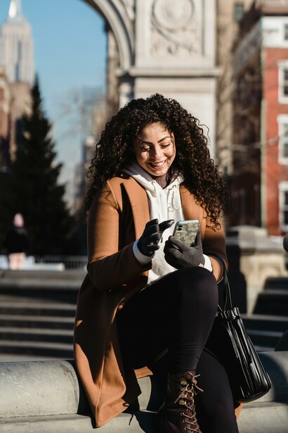 A woman using her phone outdoors 