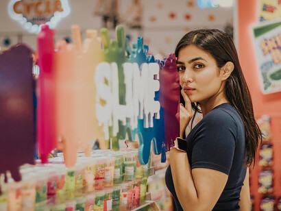 Amidst shopping in the market, a woman surveys shelves, her choices reflecting both consumer behavior and the sway of cultural norms